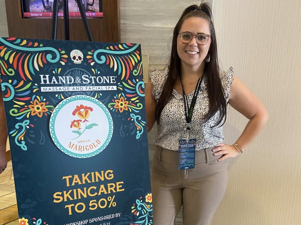 Jaclyn Palmieri posing next to hand & stone signage