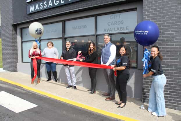 Franchise owners and team at ribbon cutting ceremony